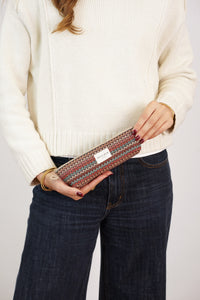 Woman holding DE LA MUR zigzag multicolor jacquard pencil case, lifestyle shot