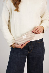 Model holding the DE LA MUR cream beige corduroy pencil case