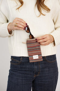 Model slipping sunglasses into DE LA MUR Zigzag Jacquard Glasses Case