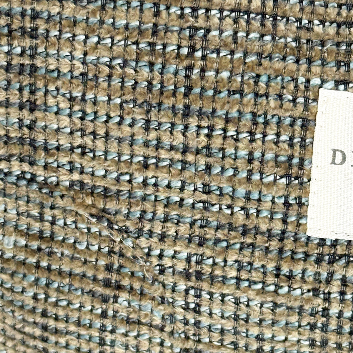 Close-up of the DE LA MUR Musa textured khaki and green woven fabric