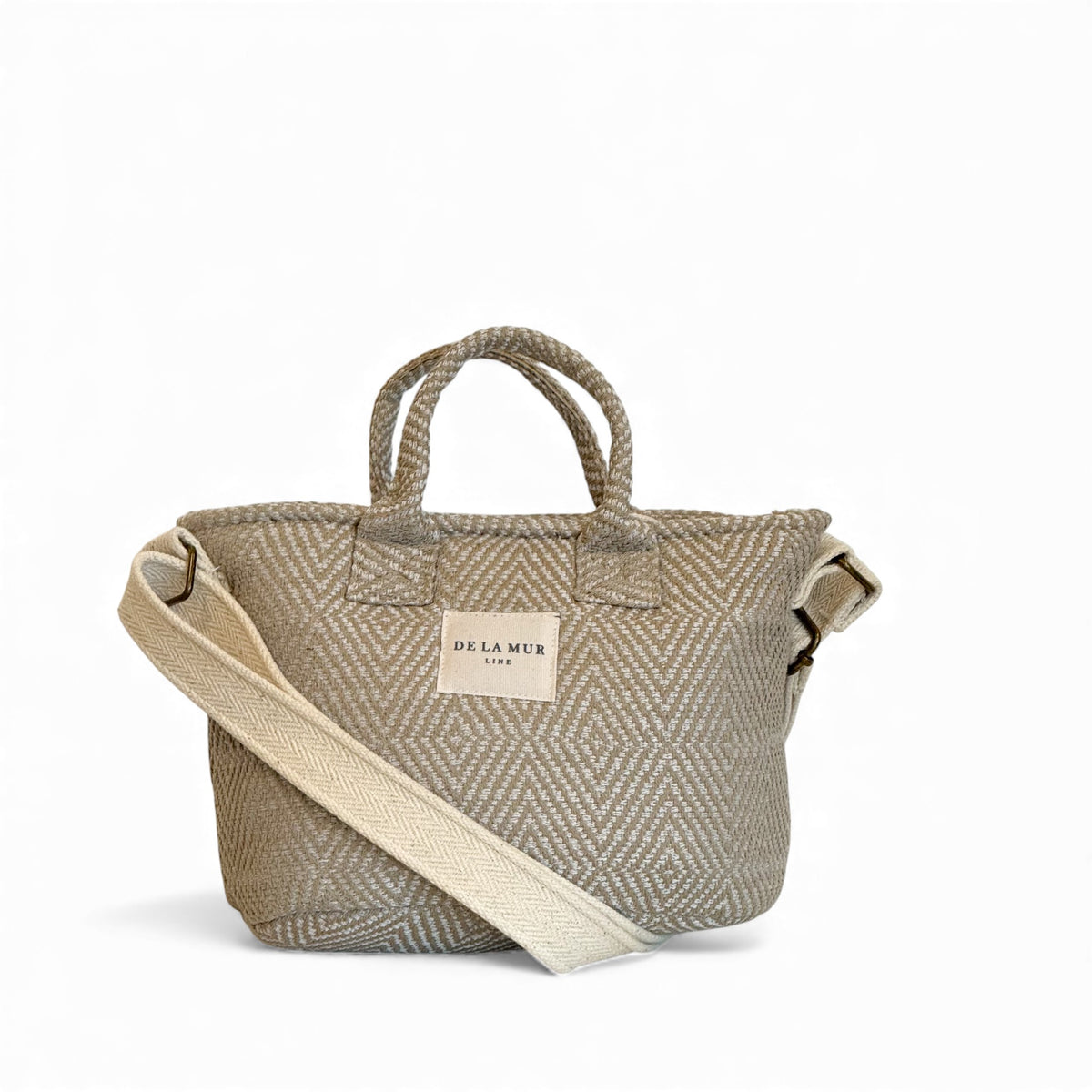 DE LA MUR Arena geometric jacquard basket handbag in off-white, front view with crossbody strap