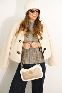 DE LA MUR faux suede small shoulder bag in camel with sherpa trim, worn crossbody