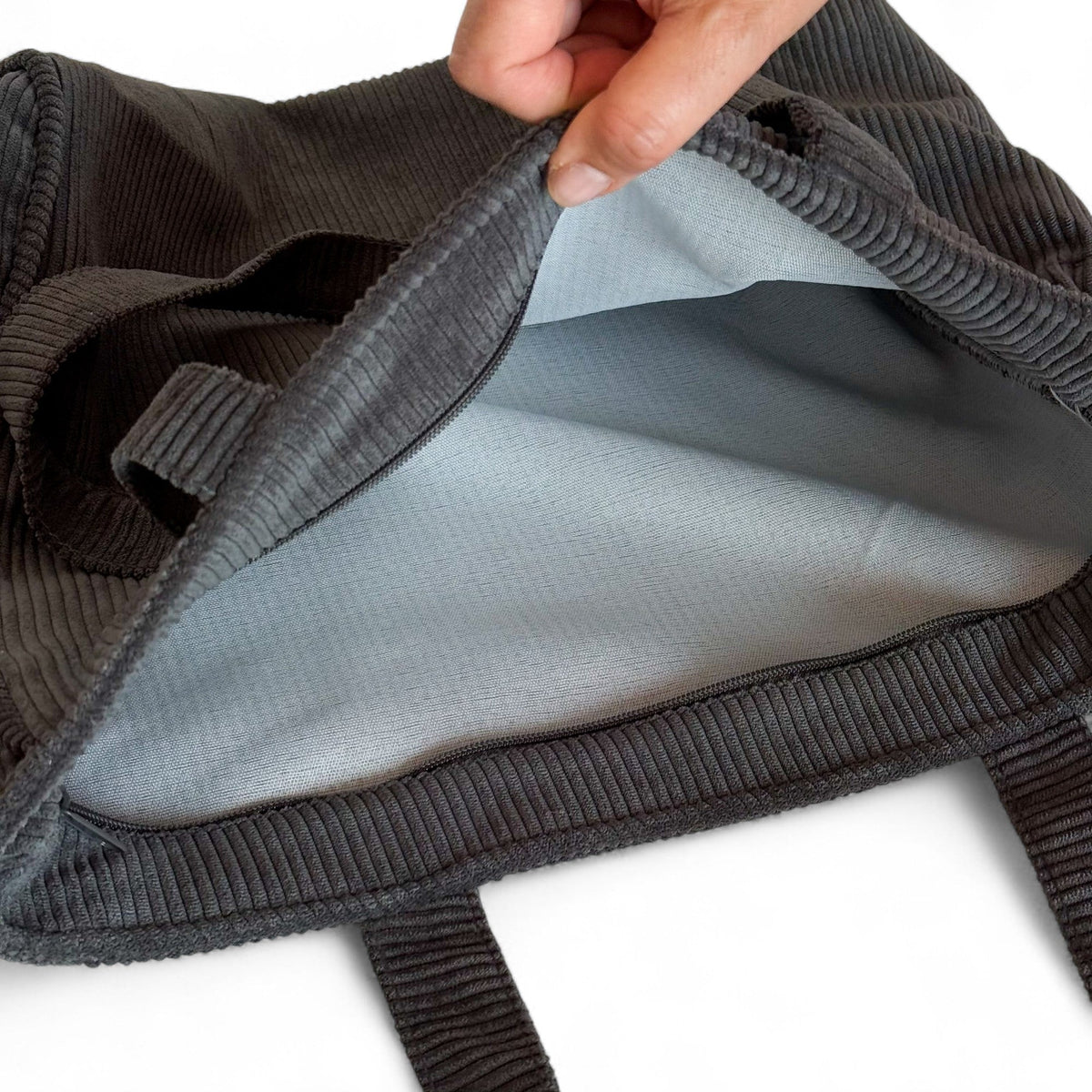 Open DE LA MUR gray corduroy tote bag showing the light lined interior