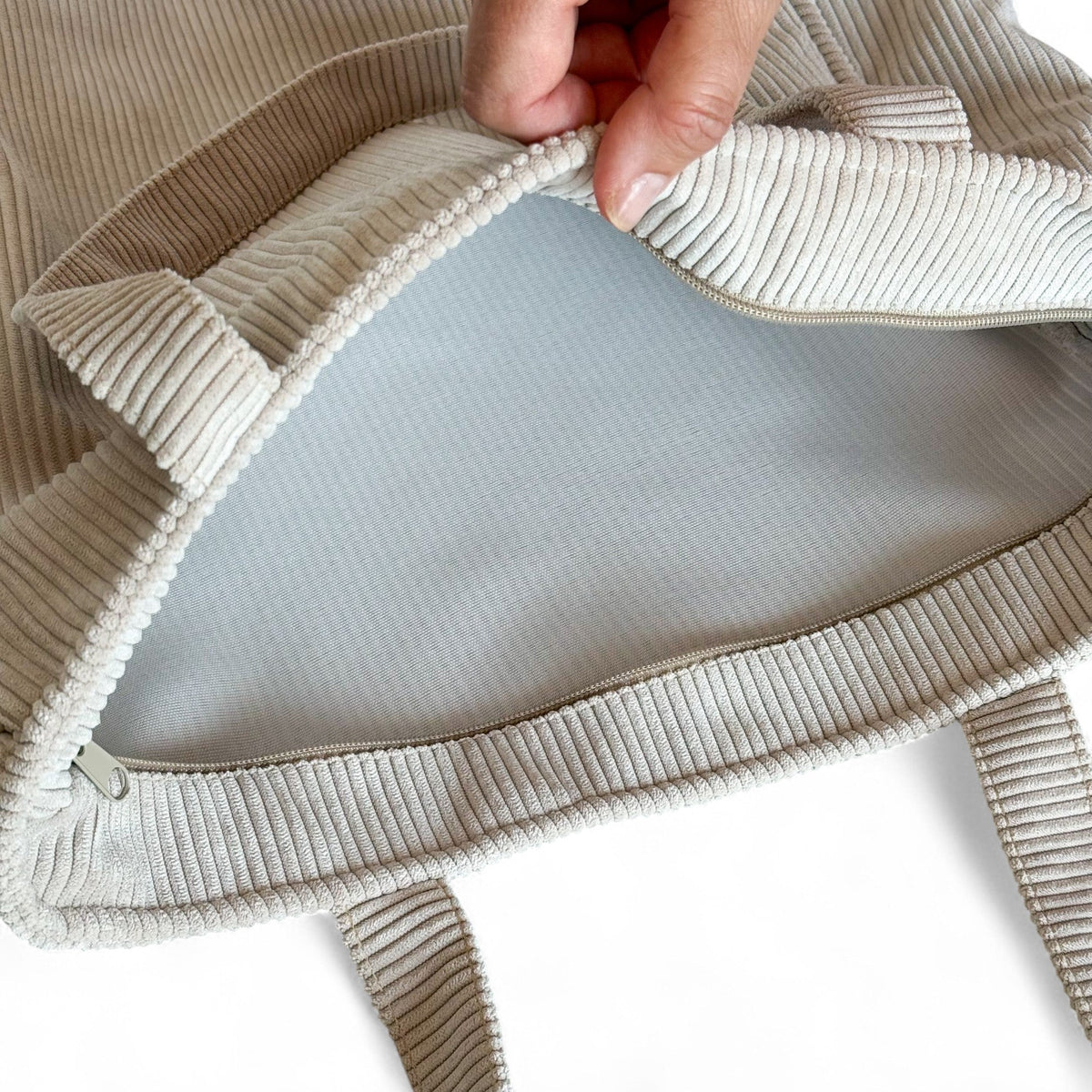 Open DE LA MUR beige corduroy tote bag showing the gray lined interior