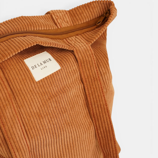 Open terracotta DE LA MUR Medium Zippered Bag showing the zip and inner label