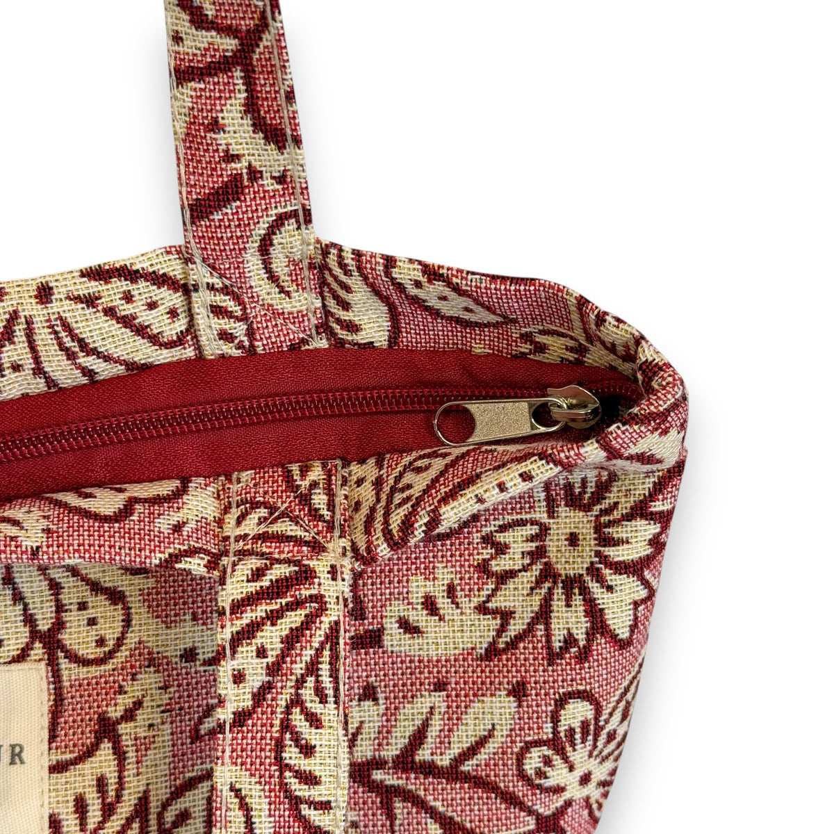 Model carrying the DE LA MUR pink floral bag, with feature highlights
