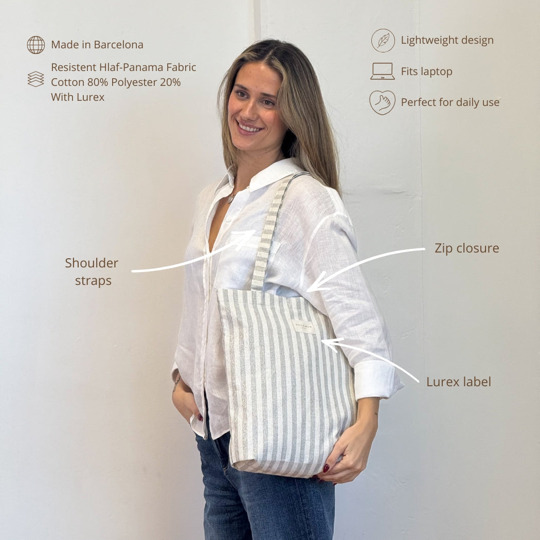 Model wearing the DE LA MUR Lugris striped bag with feature callouts