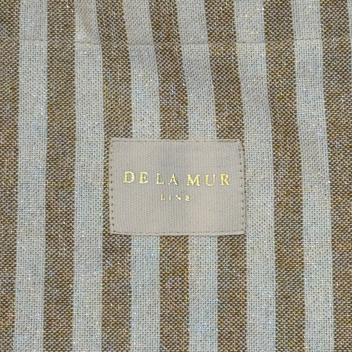 Detail of the mustard striped lurex weave and DE LA MUR Line woven label