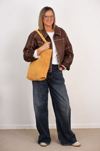 DE LA MUR Corduroy Medium Zippered Bag in mustard, worn over the shoulder