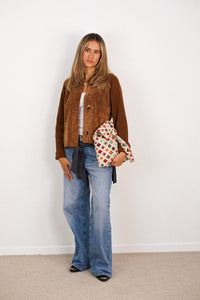 DE LA MUR cream geometric jacquard zippered bag held by a model, lifestyle view