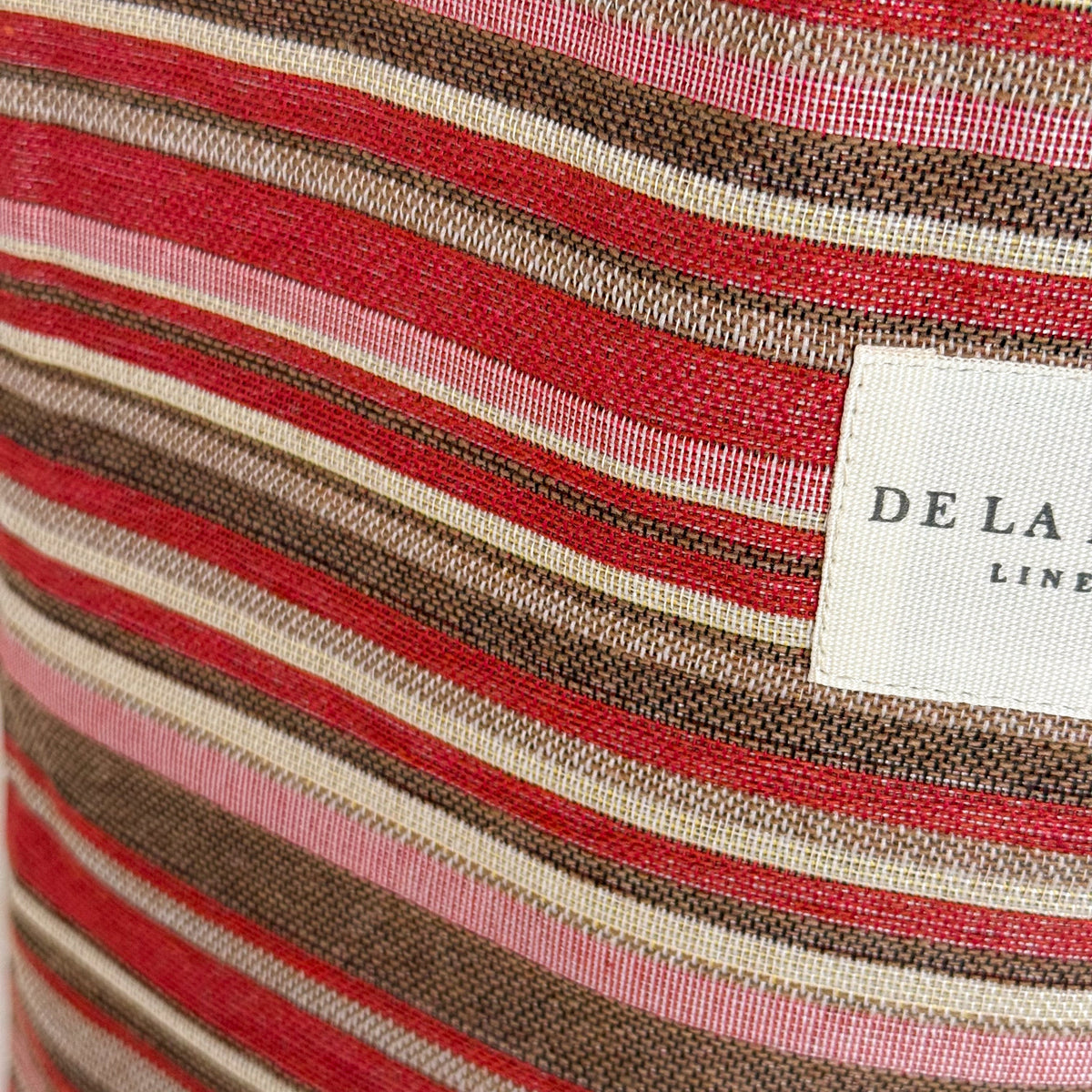 Close-up of the pink and red striped jacquard fabric and DE LA MUR Line label, Pita tote