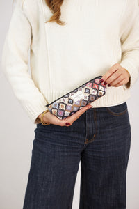 Woman holding DE LA MUR multicolor geometric jacquard pencil case, lifestyle shot