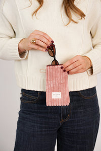 Model slipping sunglasses into the DE LA MUR Crepe dusty rose corduroy glasses case