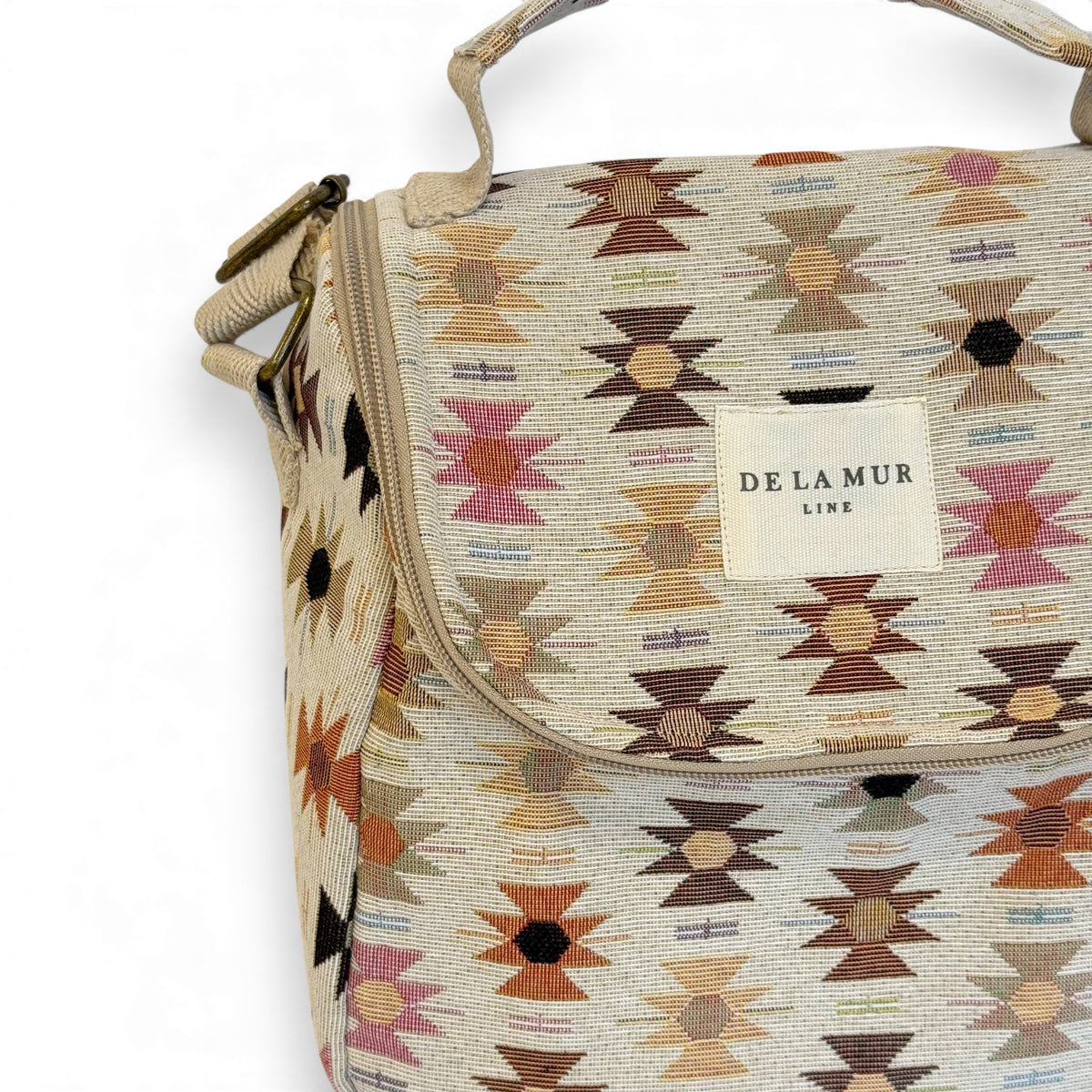 Close-up of the Royal Aztec jacquard fabric and DE LA MUR Line label