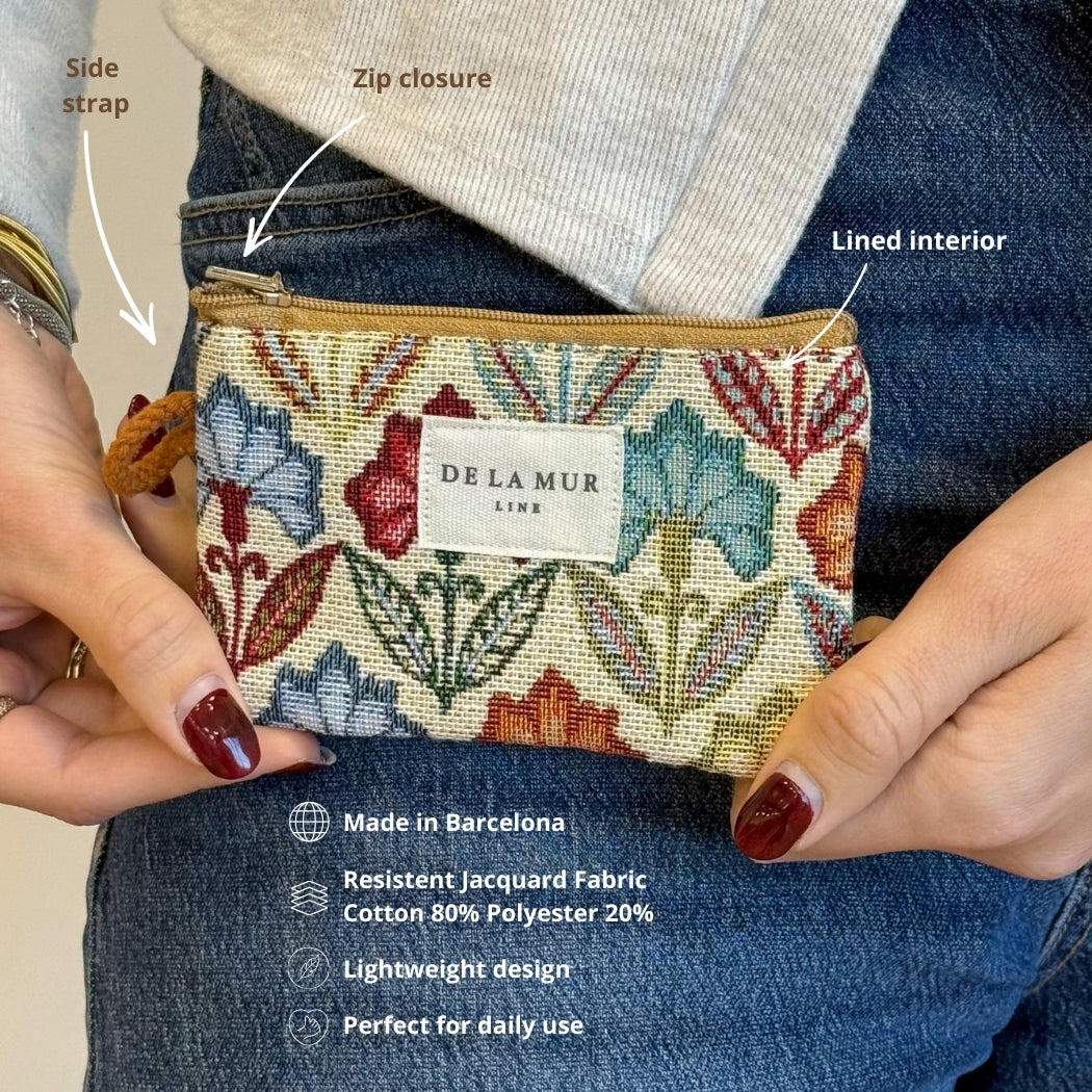 Model holding the DE LA MUR Flora floral coin purse with feature callouts