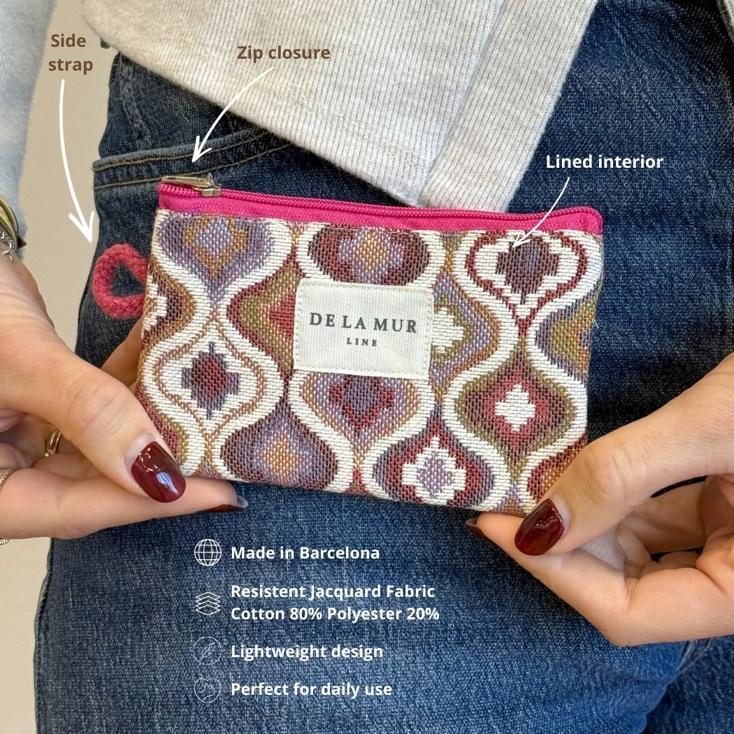 Model holding DE LA MUR Onda coin purse showing side strap, zip and lined interior features