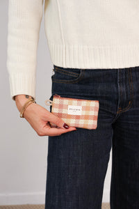 Model holding the DE LA MUR Zia gingham coin purse by a jeans pocket, lifestyle shot