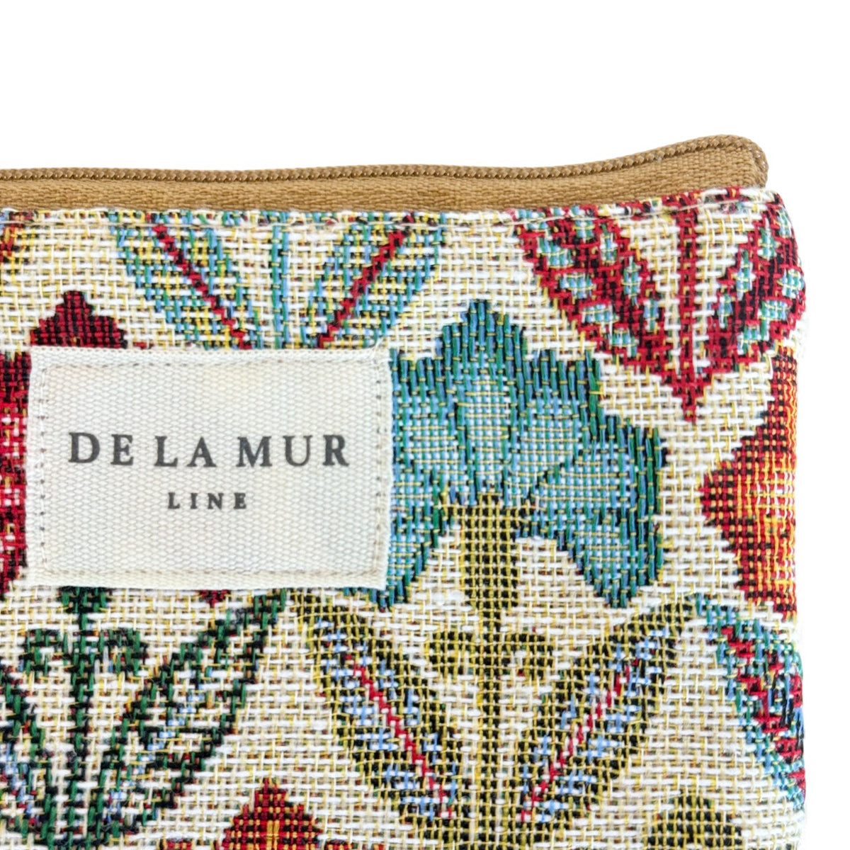 Close-up of the DE LA MUR Line label on the multicolor Flora floral jacquard bag
