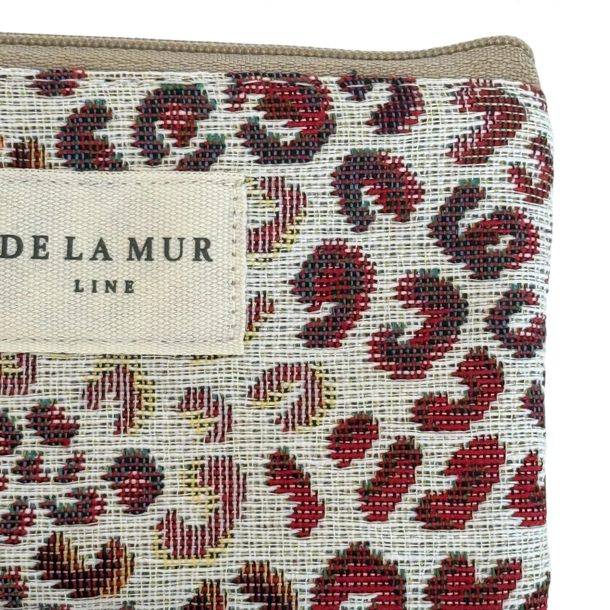 Close-up of DE LA MUR Line label on the Talco leopard-print jacquard bag