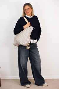 DE LA MUR Gingham Jacquard Backpack-Shoulder Bag in gray and beige, carried by a model