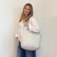 Model with the DE LA MUR Striped Large Zippered Tote Bag – Ecru & Gray (Lugris)