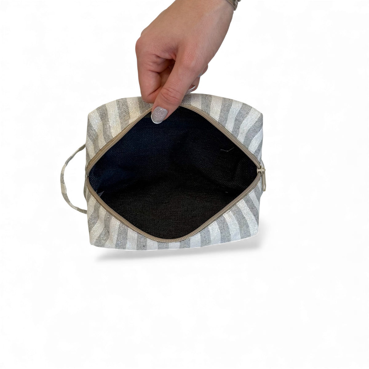 Open DE LA MUR Lugris striped makeup bag showing the dark interior