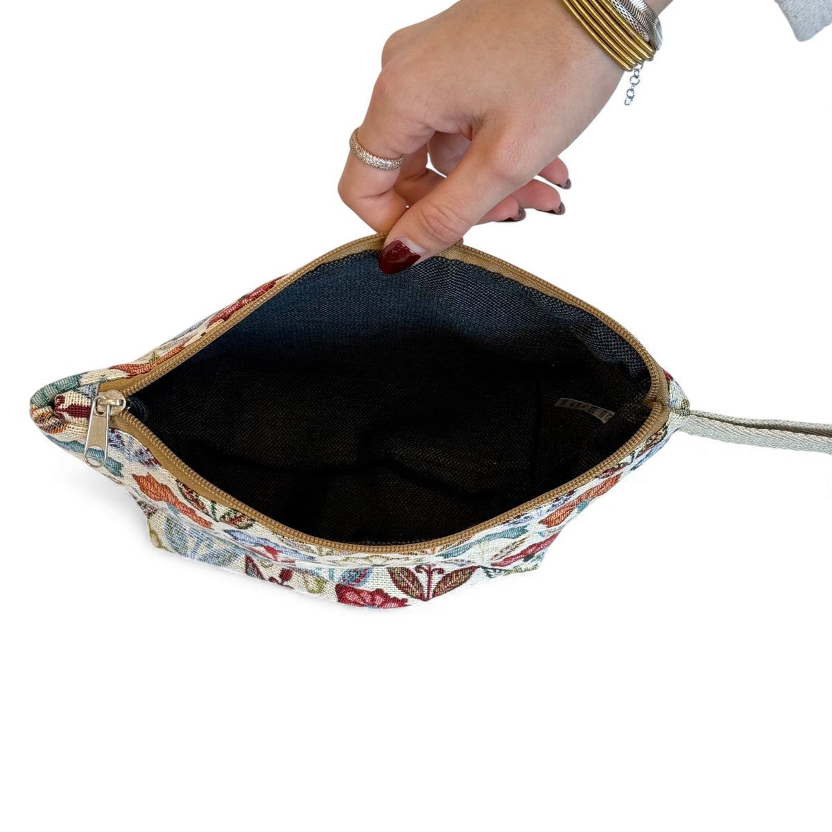 Open DE LA MUR Flora makeup bag showing the black lined interior