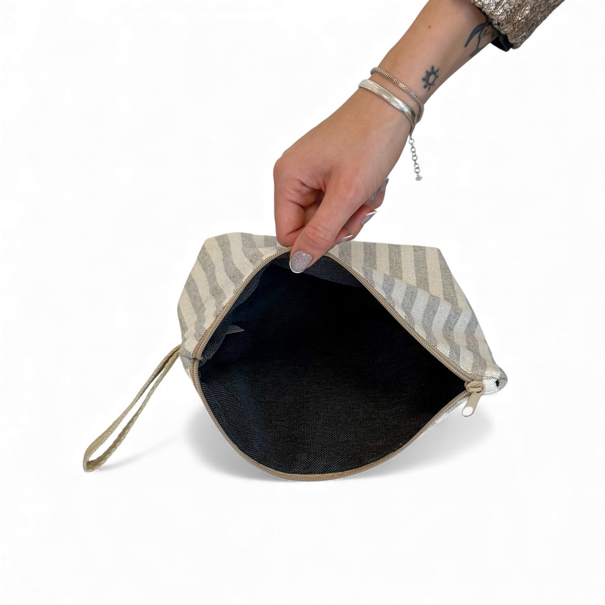 Open DE LA MUR Lugris makeup bag showing the black lined interior