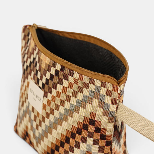 Open DE LA MUR brown & beige makeup bag showing the dark lined interior