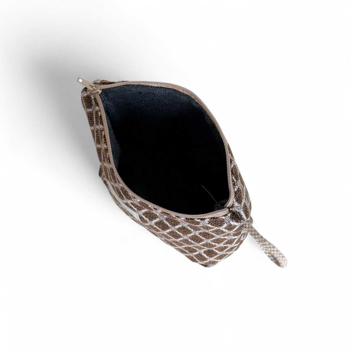 Open DE LA MUR Cobre small makeup bag from above showing the black lined interior