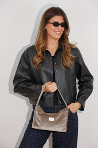 Smiling model carrying the DE LA MUR chocolate brown velvet Small Evening Bag on her shoulder