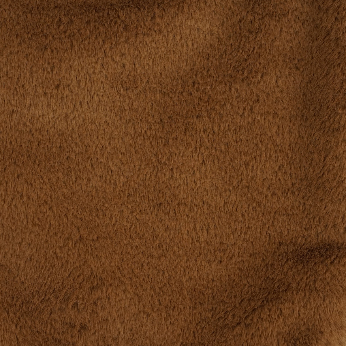 Close-up of the soft camel brown faux fur texture, DE LA MUR