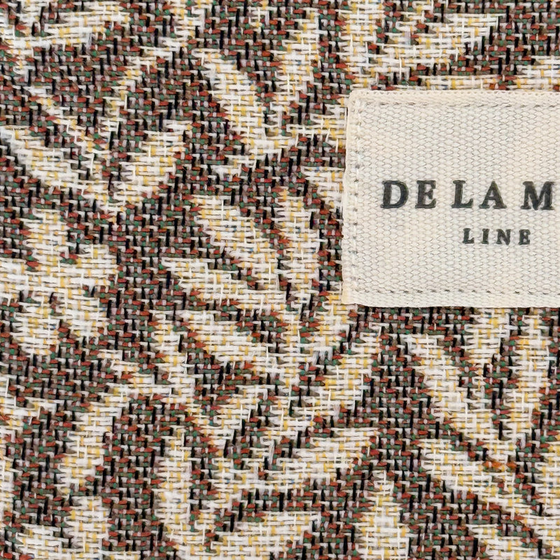 Close-up of the multicolor zigzag jacquard weave and DE LA MUR Line label