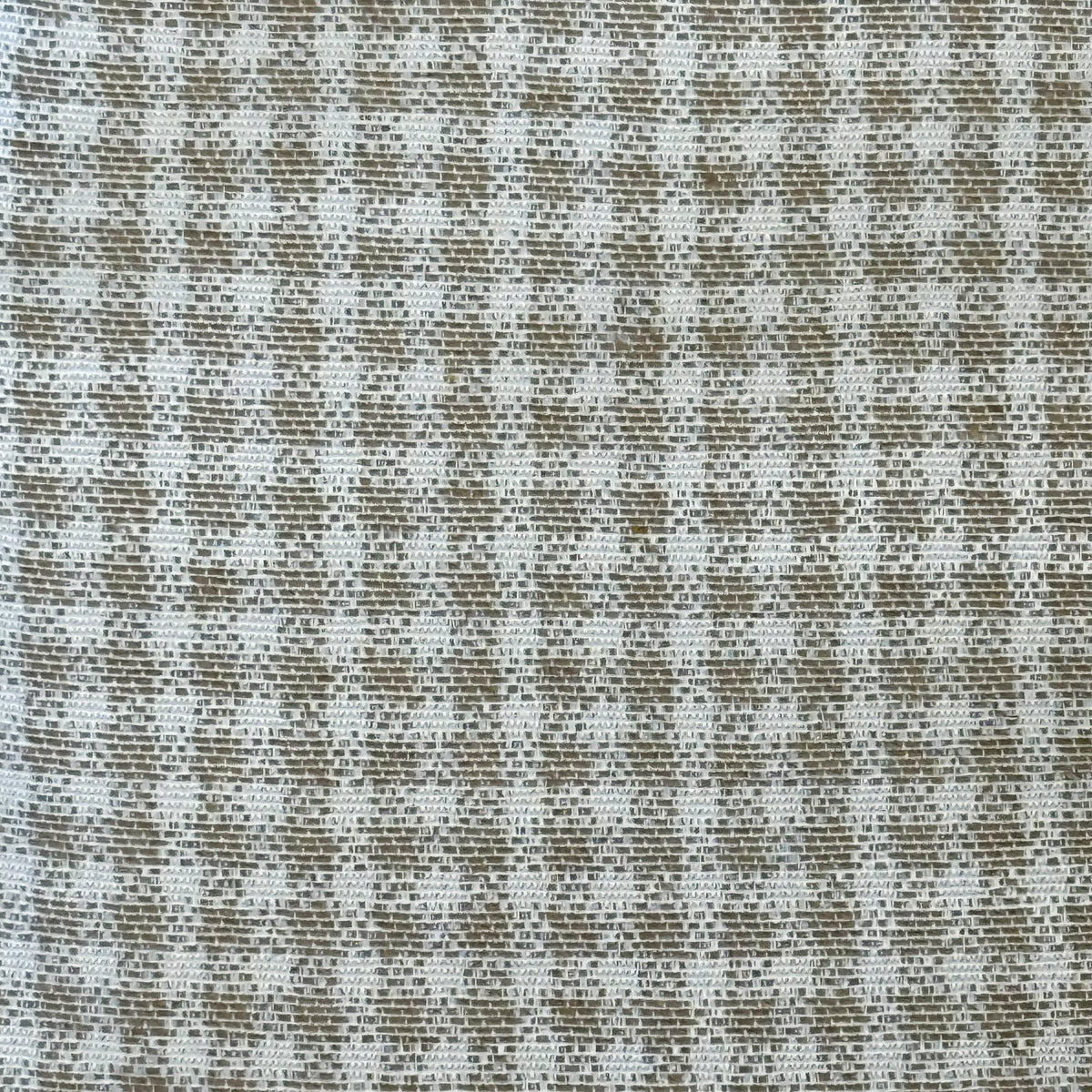 Close-up of the woven beige and off-white check jacquard fabric on the DE LA MUR fanny pack
