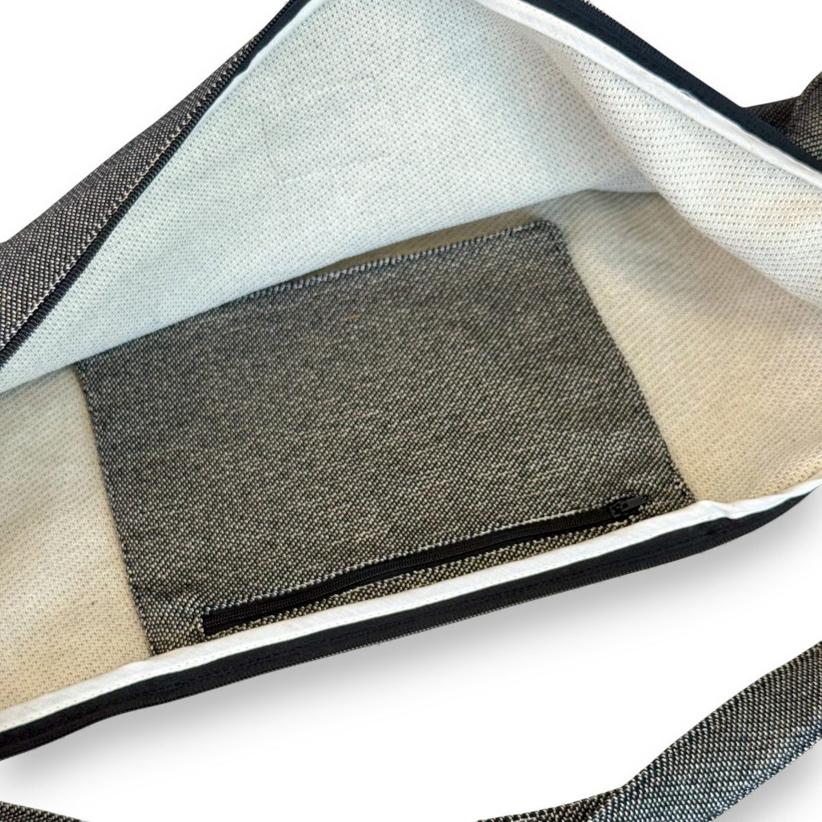 Open DE LA MUR Sinay yoga mat bag showing lined interior and inner zip pocket